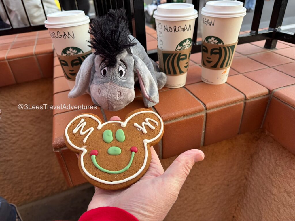 3 Lee's Travel Adventures enjoyed the Christmastime Special Mickey-shaped Gingerbread Cookie and Starbucks Caramel Brulee Latte from The Trolley Car Cafe at Disney's Hollywood Studios in 2024. Adventure Eeyore enjoyed them too.