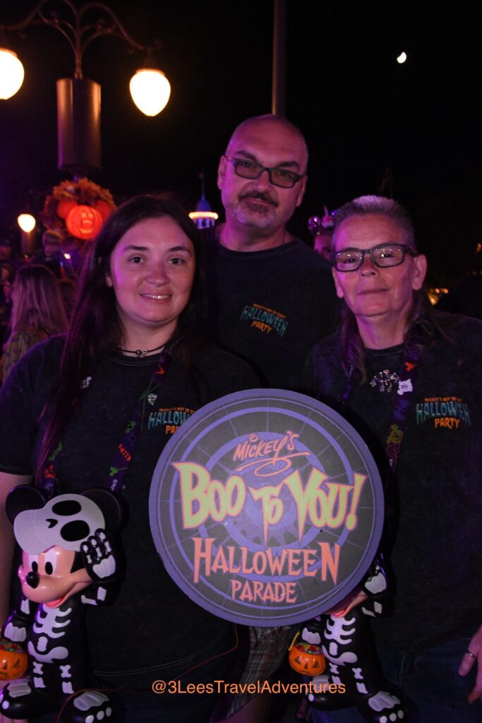 3 Lee's Travel Adventures loved getting their picture taken before the parade with the Party Exclusive Mickey's "Boo-to-You" Halloween Parade Sign in 2023.